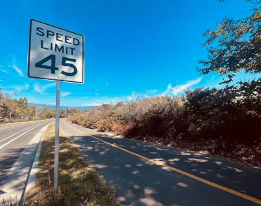 empty highway and speed limit sign